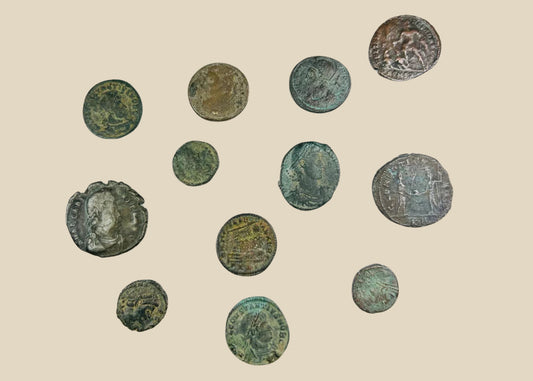 Collection of 12 ancient Roman bronze coins, varying in size and condition, featuring worn imperial busts and reverse imagery; authentic hoard of currency from the Roman Empire with patinated surfaces and archaeological character.