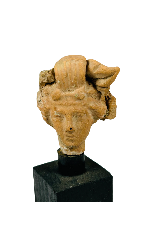 Ancient terracotta female head sculpture in classical style with detailed headdress