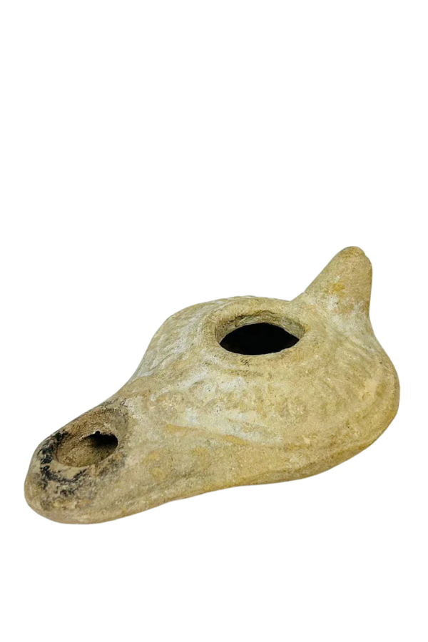 Ancient terracotta oil lamp with filling hole and spout used for burning oil