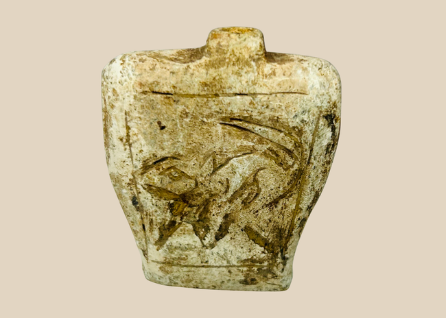 Ancient carved stone amulet flask with double-sided relief motifs and burial patina