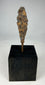 Ancient iron arrowhead relic mounted on black display base, front view.
