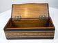 Open Anglo-Indian marquetry box showing natural wood interior and brass hinges