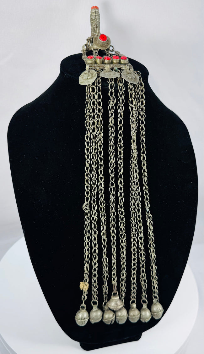 Historic Kuchi pendant ornament from Afghanistan featuring a hirz prayer tube, red cabochons, and bell-shaped dangles.