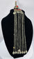 Historic Kuchi pendant ornament from Afghanistan featuring a hirz prayer tube, red cabochons, and bell-shaped dangles.