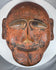 Traditional tribal wooden mask displaying abstract facial forms and authentic aged wear