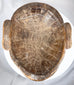Antique African tribal mask with remnants of pigment and expressive anthropomorphic form