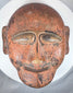 African ethnographic ceremonial mask with weathered surface, carved details, and ritual character