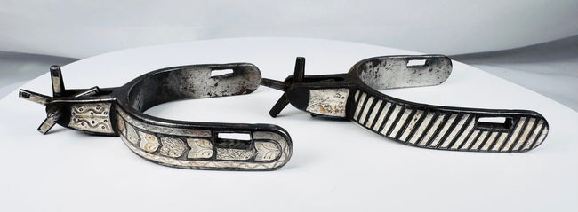 Early 20th-century American cowboy spurs with silver decoration and aged patina