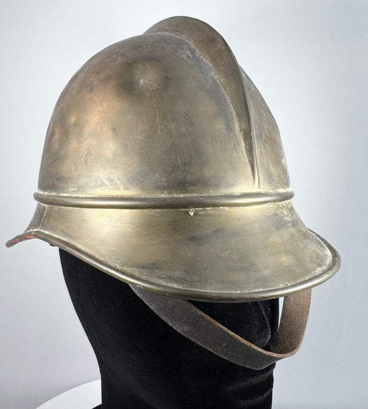 Antique Bavarian firefighter helmet showing broad rear brim and longitudinal brass comb, circa 1908–1934