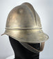 Antique Bavarian firefighter helmet showing broad rear brim and longitudinal brass comb, circa 1908–1934