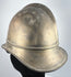 Bavarian brass firefighter helmet showing raised crown comb and aged metal patina, circa 1908–1934