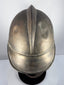 Antique German firefighter helmet showing brass shell, broad brim and leather chinstrap, circa 1908–1934