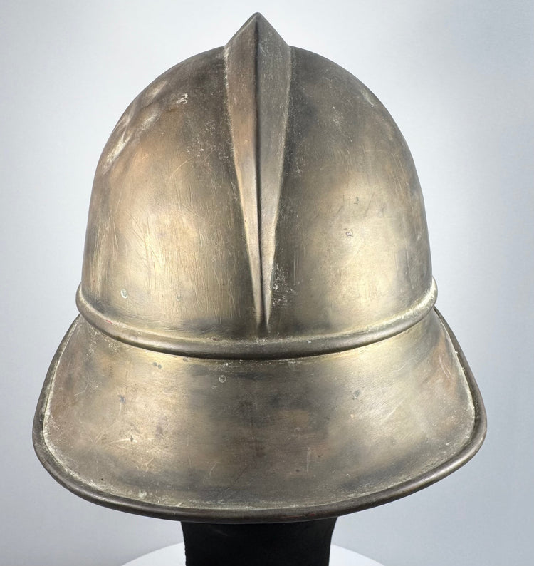 German brass Feuerwehrhelm showing rounded side profile and historic surface wear, circa 1908–1934