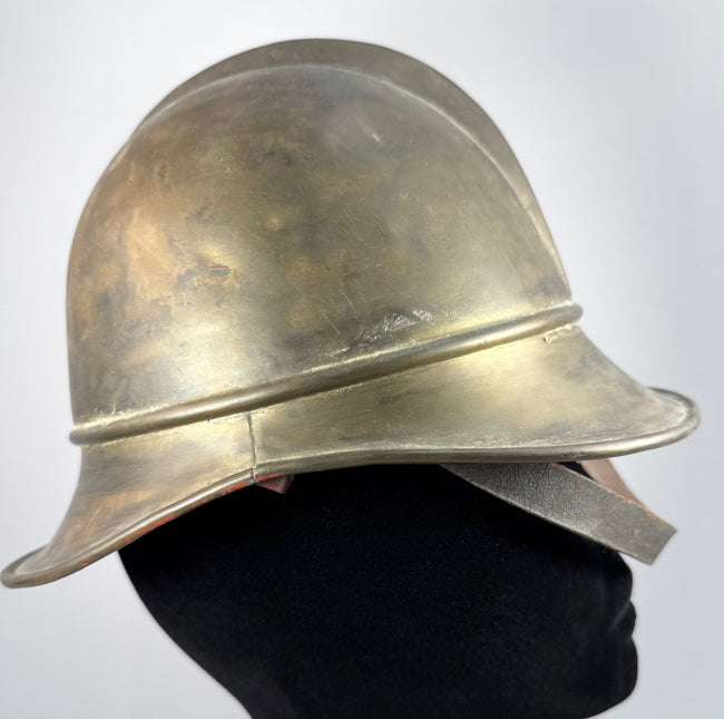 Antique German Feuerwehrhelm showing curved rear neck guard and brass construction, circa 1908–1934