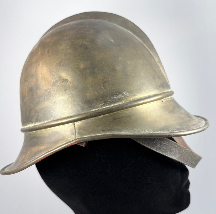 Antique German Feuerwehrhelm showing curved rear neck guard and brass construction, circa 1908–1934