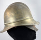 Antique German Feuerwehrhelm showing curved rear neck guard and brass construction, circa 1908–1934