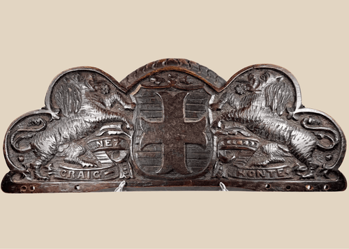 Antique Bentinck family heraldic oak pediment with cross moline, paired lions, and Craignez Honte motto