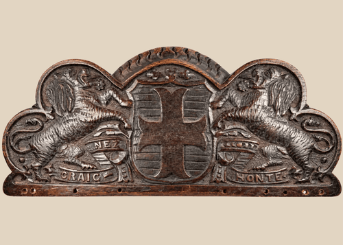 Antique Bentinck family heraldic oak pediment with cross moline, paired lions, and Craignez Honte motto