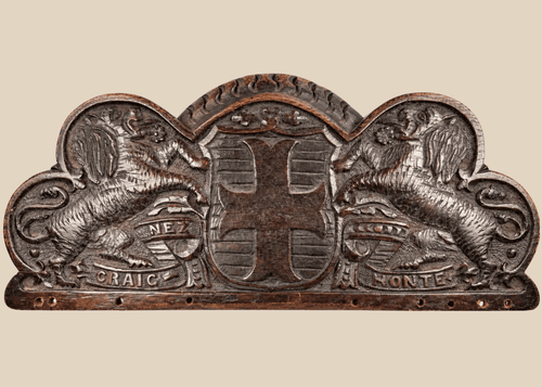 Antique Bentinck family heraldic oak pediment with cross moline, paired lions, and Craignez Honte motto