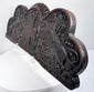 Close-up of the weathered oak surface, carved lion, heraldic shield, and naturally developed wear