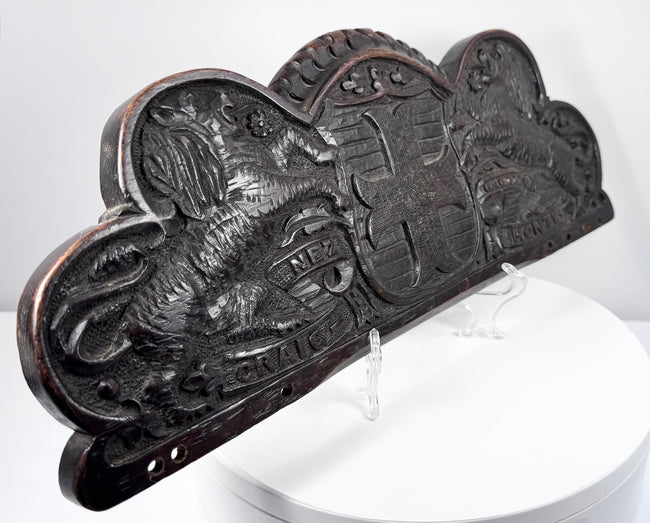 Side view of an 18th–19th-century carved oak furniture or architectural pediment with dark patina