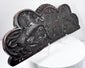 Side view of an 18th–19th-century carved oak furniture or architectural pediment with dark patina
