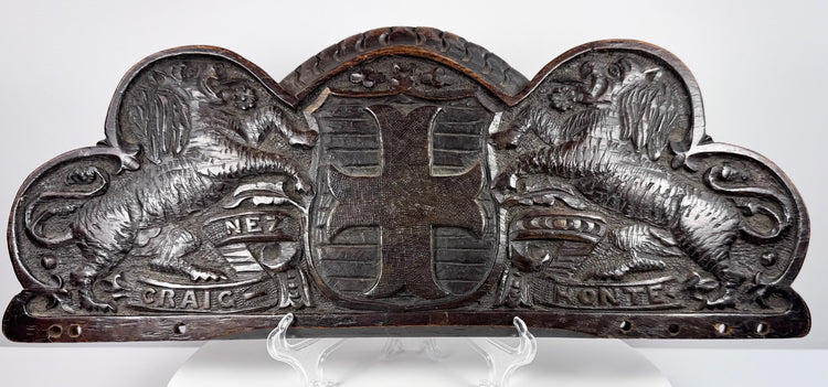 Antique carved oak pediment with two double-queued heraldic lions flanking a central coat of arms