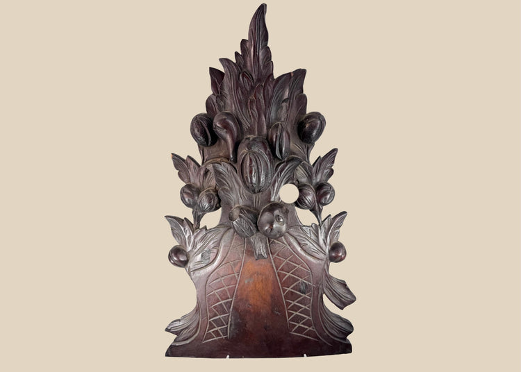 Antique European Black Forest-style carved wood furniture crest with overflowing fruit basket, foliage and deep reddish-brown patina