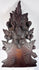 Black Forest-style carved furniture ornament showing dense botanical decoration, applied carved elements and historic surface wear