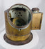 Antique shipboard navigational compass with aged brass patina and flanged mounting base