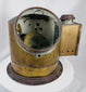 Antique shipboard navigational compass with aged brass patina and flanged mounting base