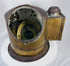 Antique nautical compass housed in a brass binnacle with circular glass viewing window
