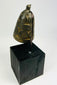 Tibetan Buddhist ritual bell with domed body and intact iron clapper interior.