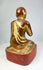 Rear view of hand-carved 19th-century Burmese monk statue, showing aging lacquer and wooden texture.