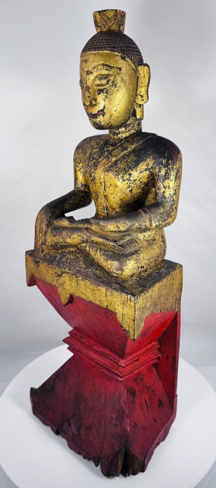 Late 19th century Burmese Shan Buddha with red lacquered plinth and gilded surface.