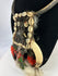 Oceanic tribal necklace combining natural fibers, shell, bone, and feathers