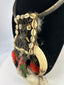 Oceanic tribal necklace combining natural fibers, shell, bone, and feathers