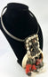 Traditional Melanesian necklace with curved shell elements and red-black feathers