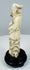 Rear view of the sectionally carved Chinese immortal figure and scholar’s cap
