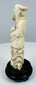Rear view of the sectionally carved Chinese immortal figure and scholar’s cap