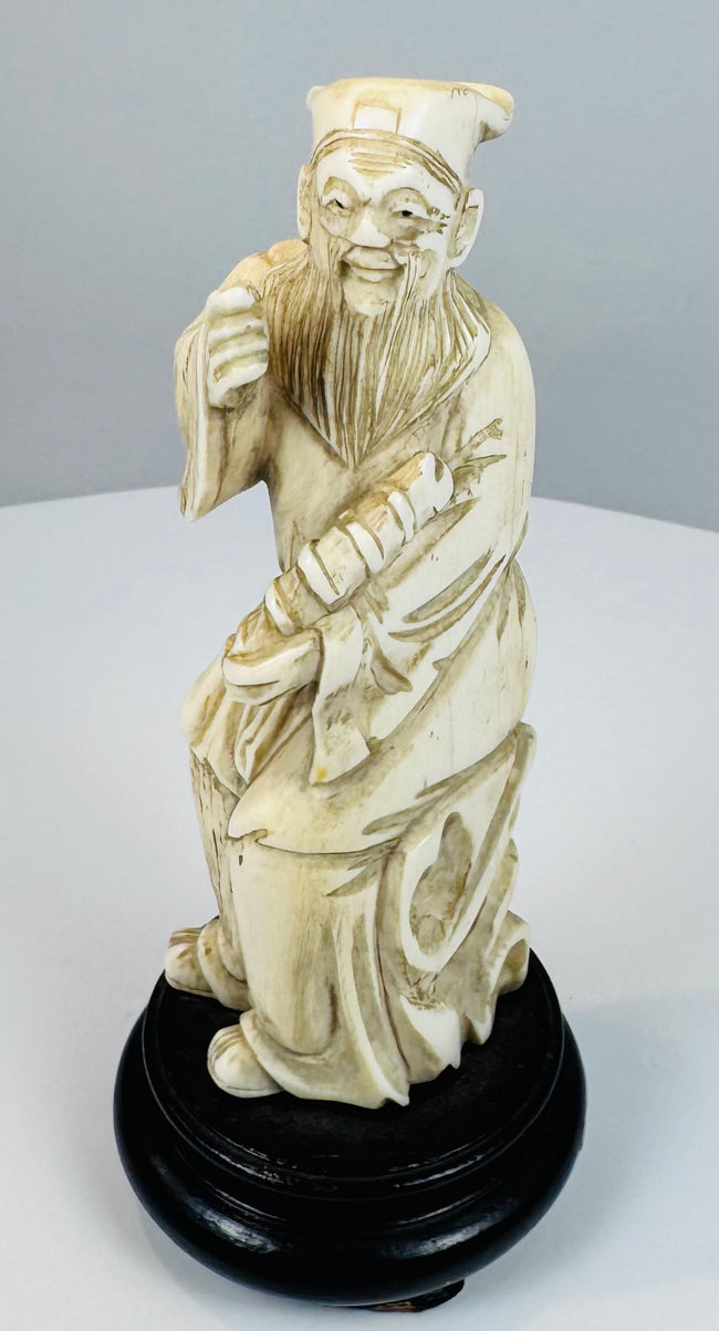 Front view of a late Qing Zhang Guolao figure holding a bamboo yugu drum