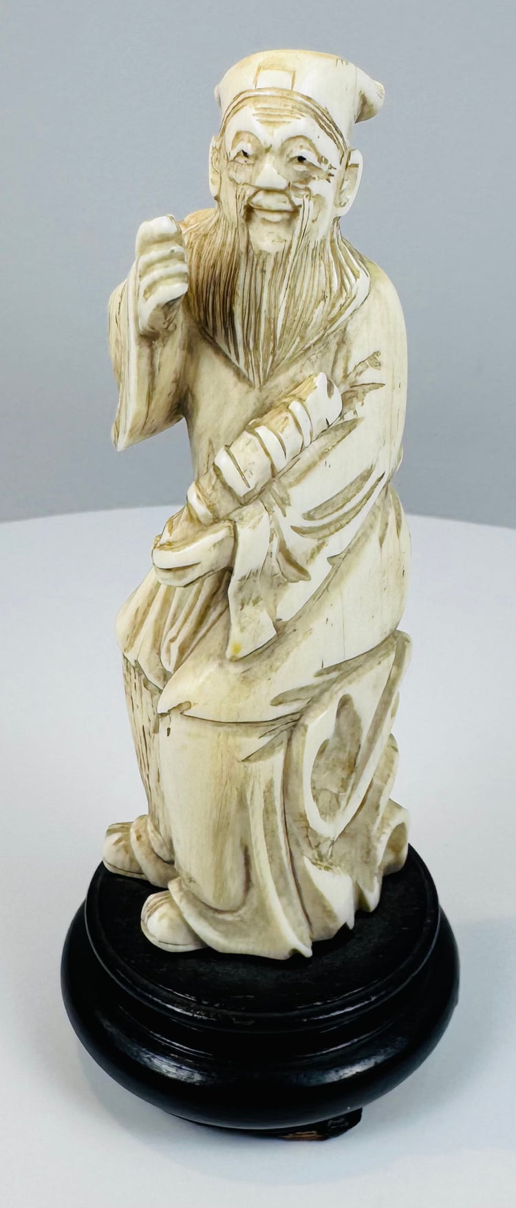 Chinese Eight Immortals carving of Zhang Guolao on an ebonized wood base
