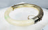 Vintage hinged bracelet with natural green stone inclusions and marked silver fittings