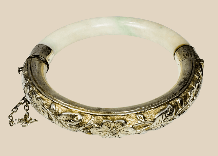 Antique Chinese jade or hardstone bracelet with marked silver floral mounts