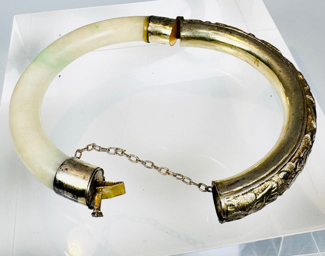 Antique pale green hardstone bangle mounted in chased silver fittings