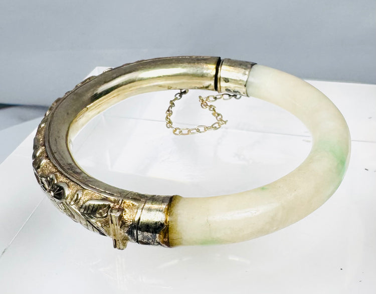 Antique Asian jewelry bracelet with pale stone segment and ornate silver floral panel