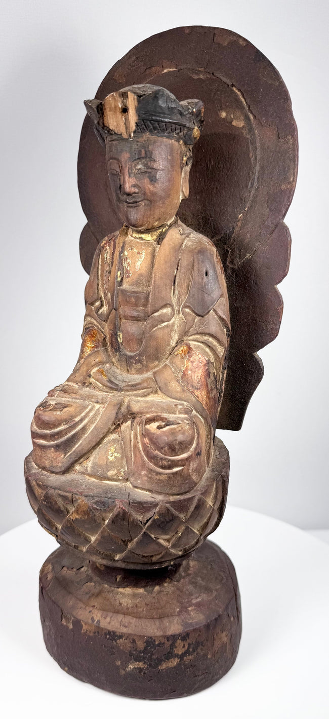Antique Chinese devotional sculpture of Guanyin seated upon a carved lotus pedestal with aged lacquer and gilt decoration