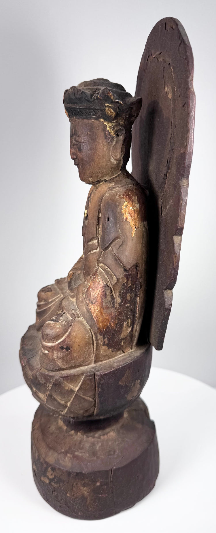 Chinese giltwood Guanyin statue with separately carved mandorla forming a sacred halo behind the seated bodhisattva