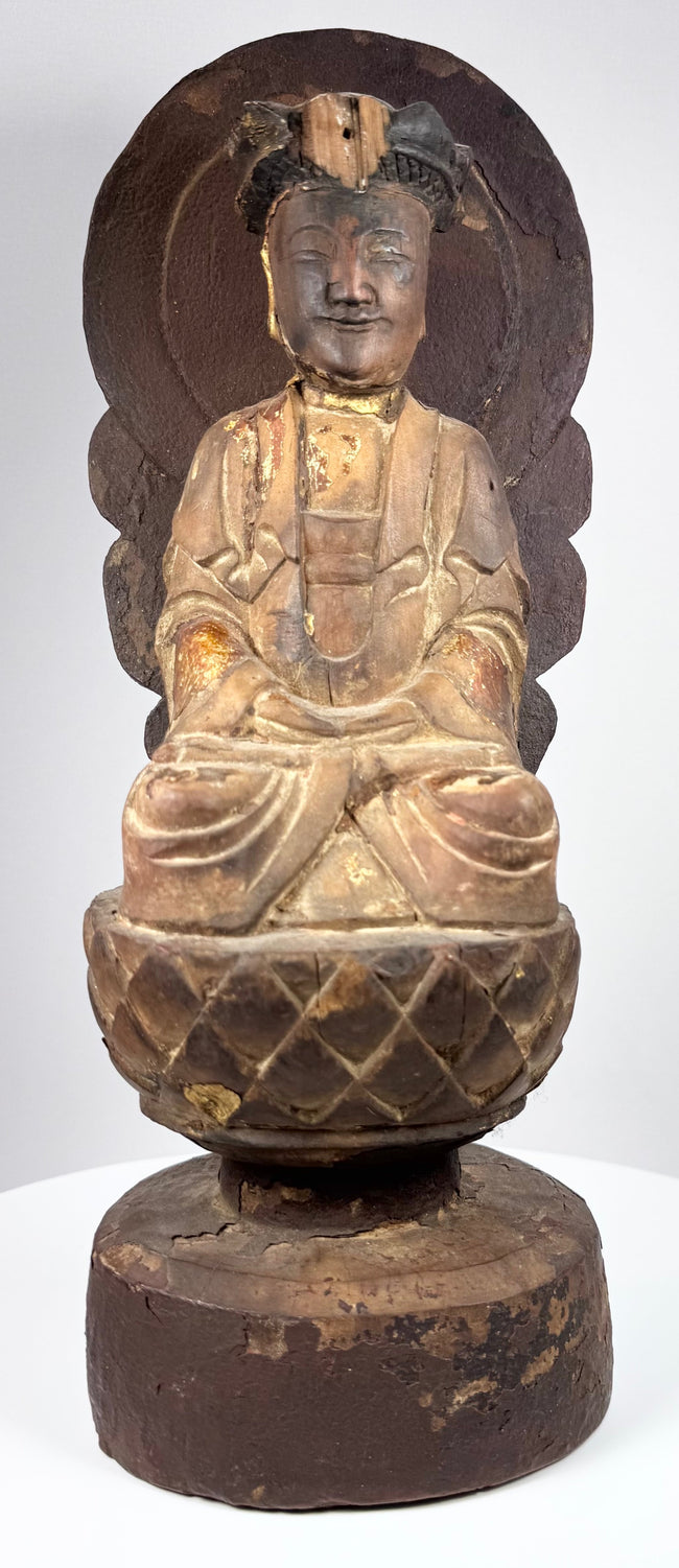 Chinese Buddhist Guanyin seated in meditation with hands arranged in dhyana mudra and flowing ceremonial robes