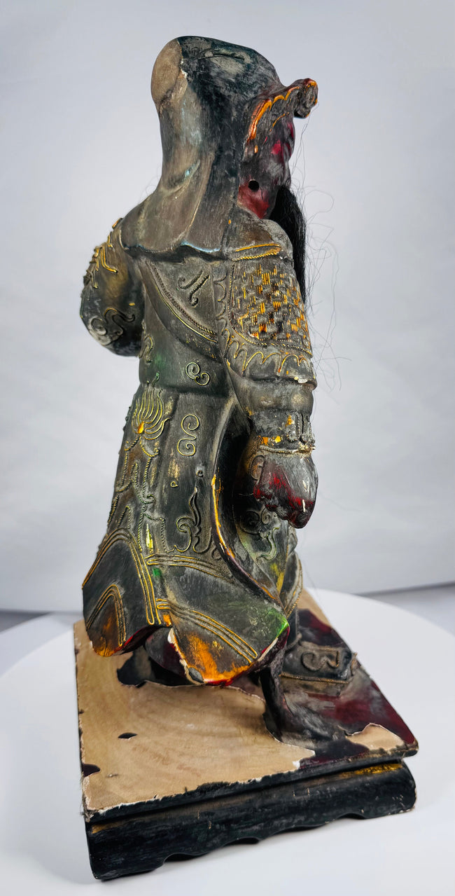 Chinese protective deity figure with elaborate armour and missing handheld weapon